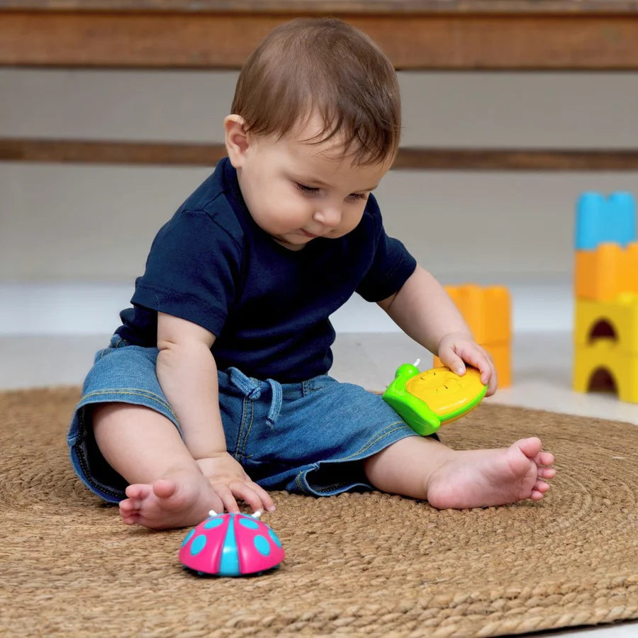 little boy with snail and ladybug shaker
