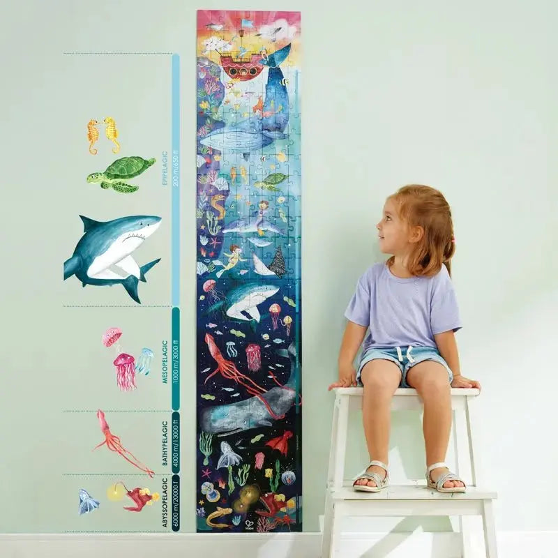 kid sitting next to completed puzzle