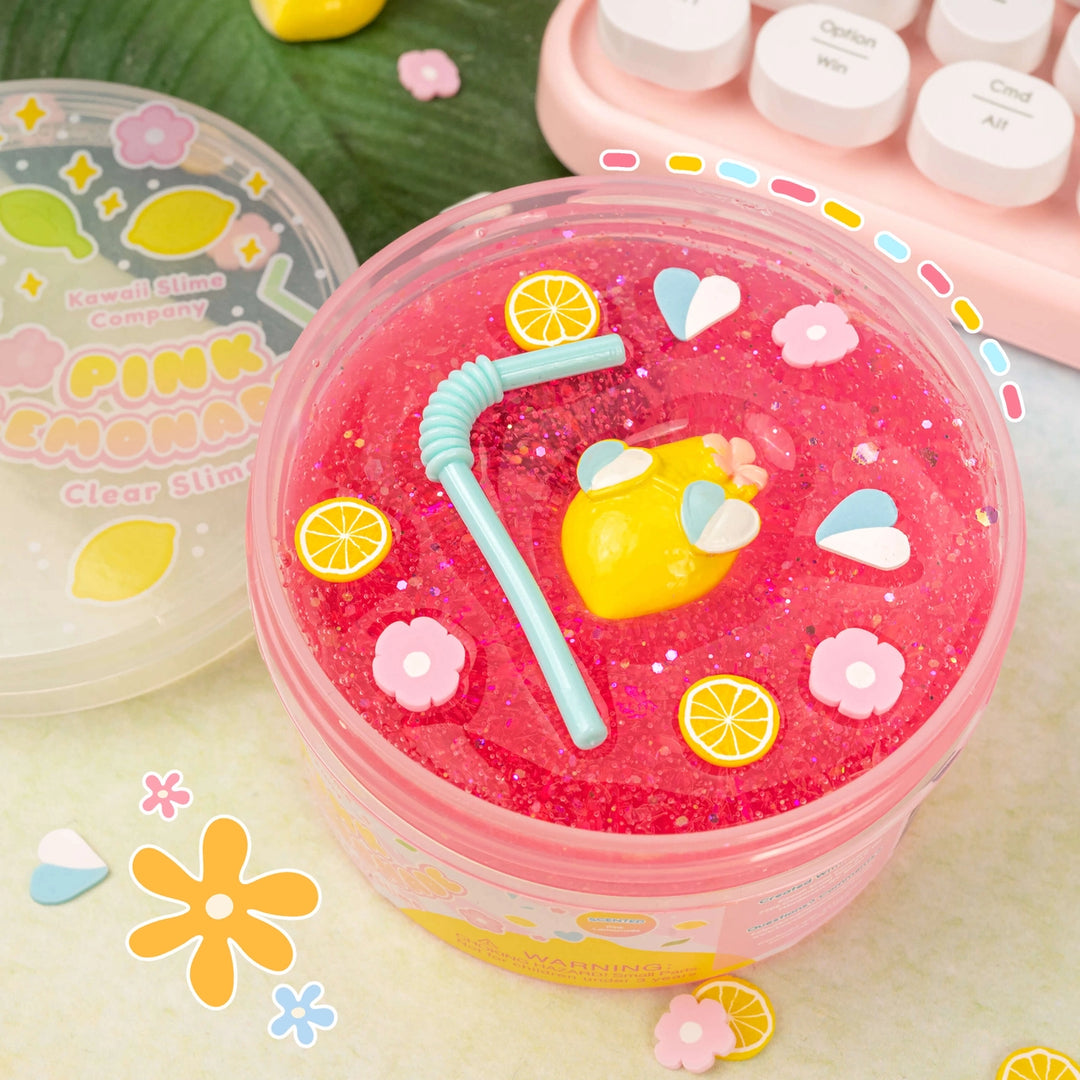 pink lemonade slime in packaging with lid off and charms on top