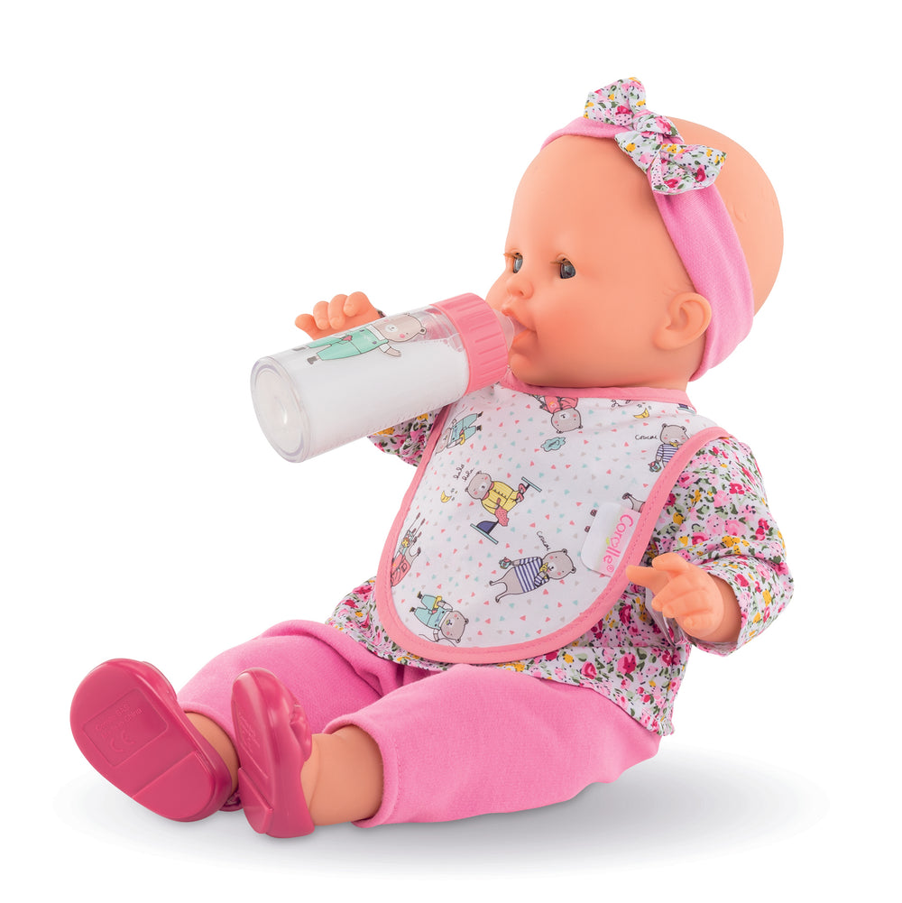 baby doll wearing bib and using milk bottle