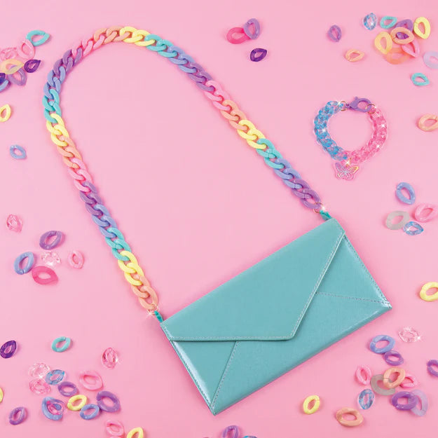Pink background with a blue purse and handle made of links from kit