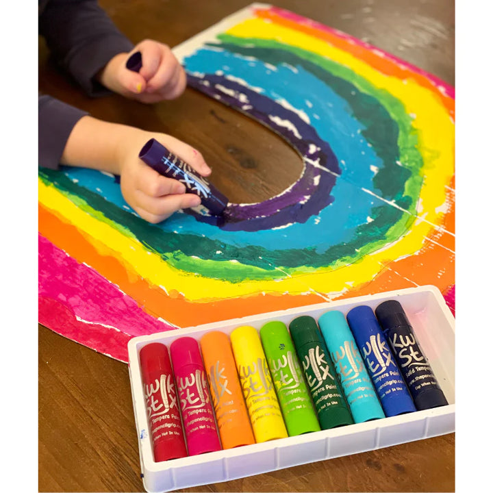 kid drawing rainbow with kwik stix