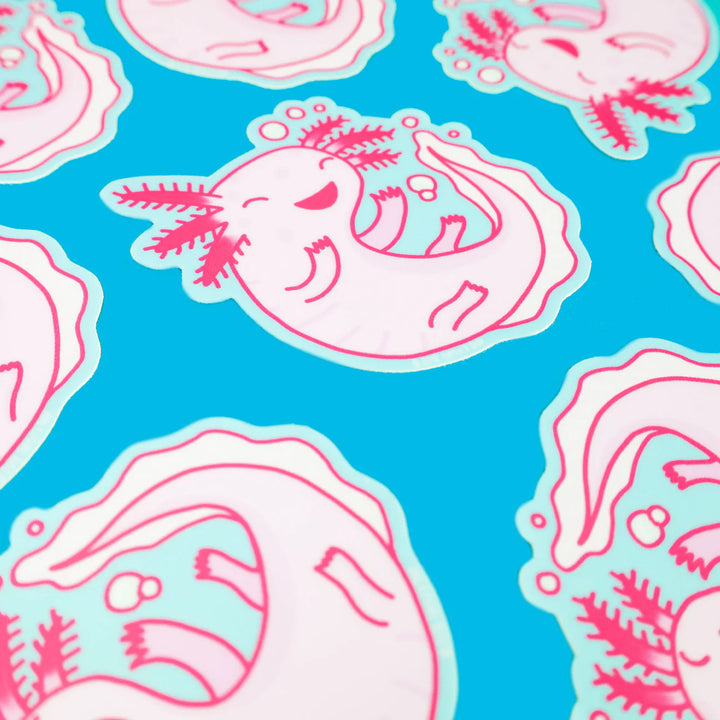 scattered cute pink axolotl laughing vinyl stickers on blue background