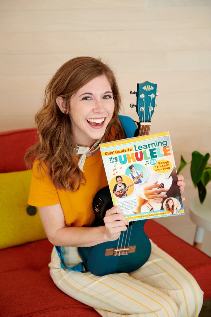 Emily Arrow holding ukulele and Kid's Guide to Learning the Ukulele Book 