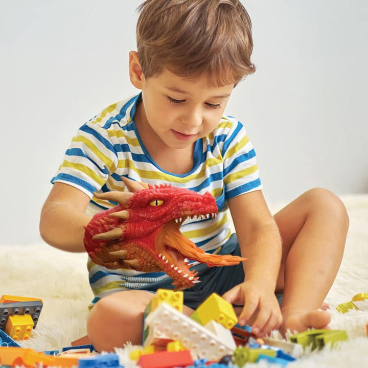 little kid playing with red dragon
