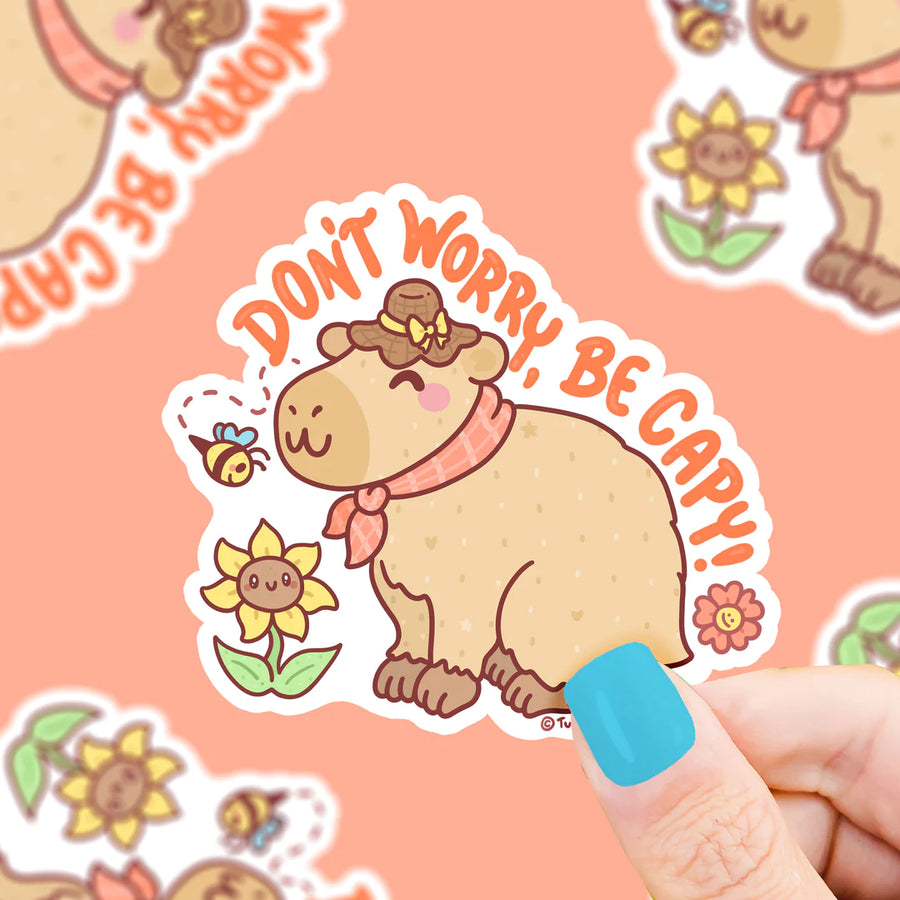 Happy Capybara smelling a flower vinyl sticker