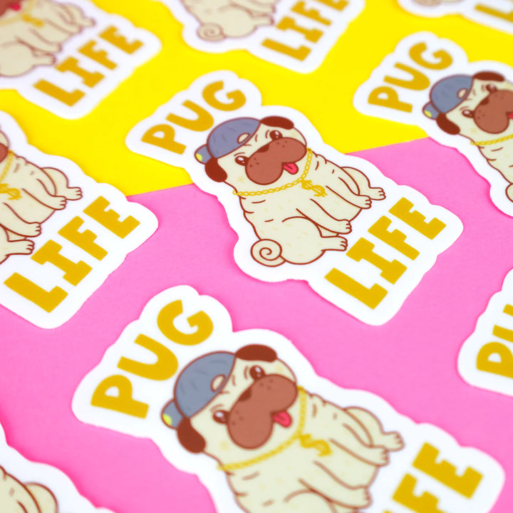 Funny pug with hat and chain sticker with words pug life scattered on pink and yellow background