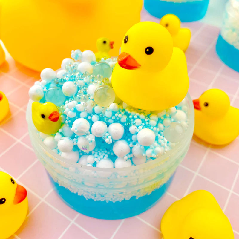 front angled view of open squeaky clean bubble bath slime with accompanying rubber ducks