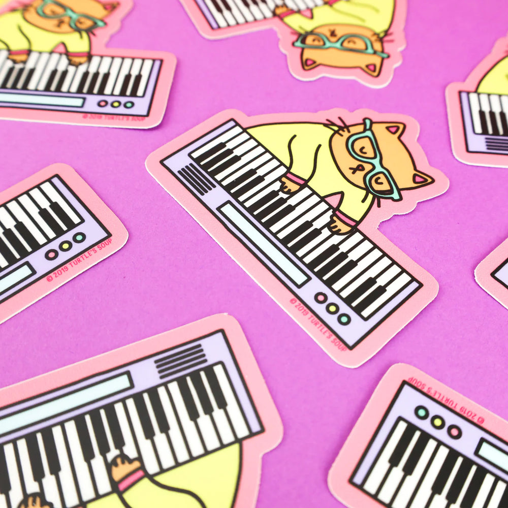 Keyboard cat vinyl stickers scattered on purple background