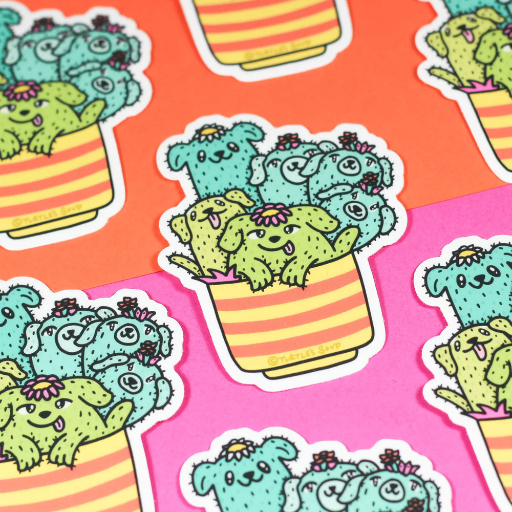 cactus pups in a planter vinyl sticker scattered on an orange and pink background