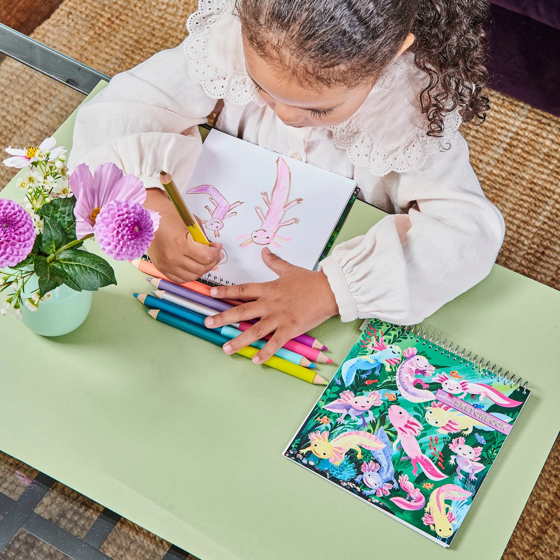 example of little girl coloring with colored pencils