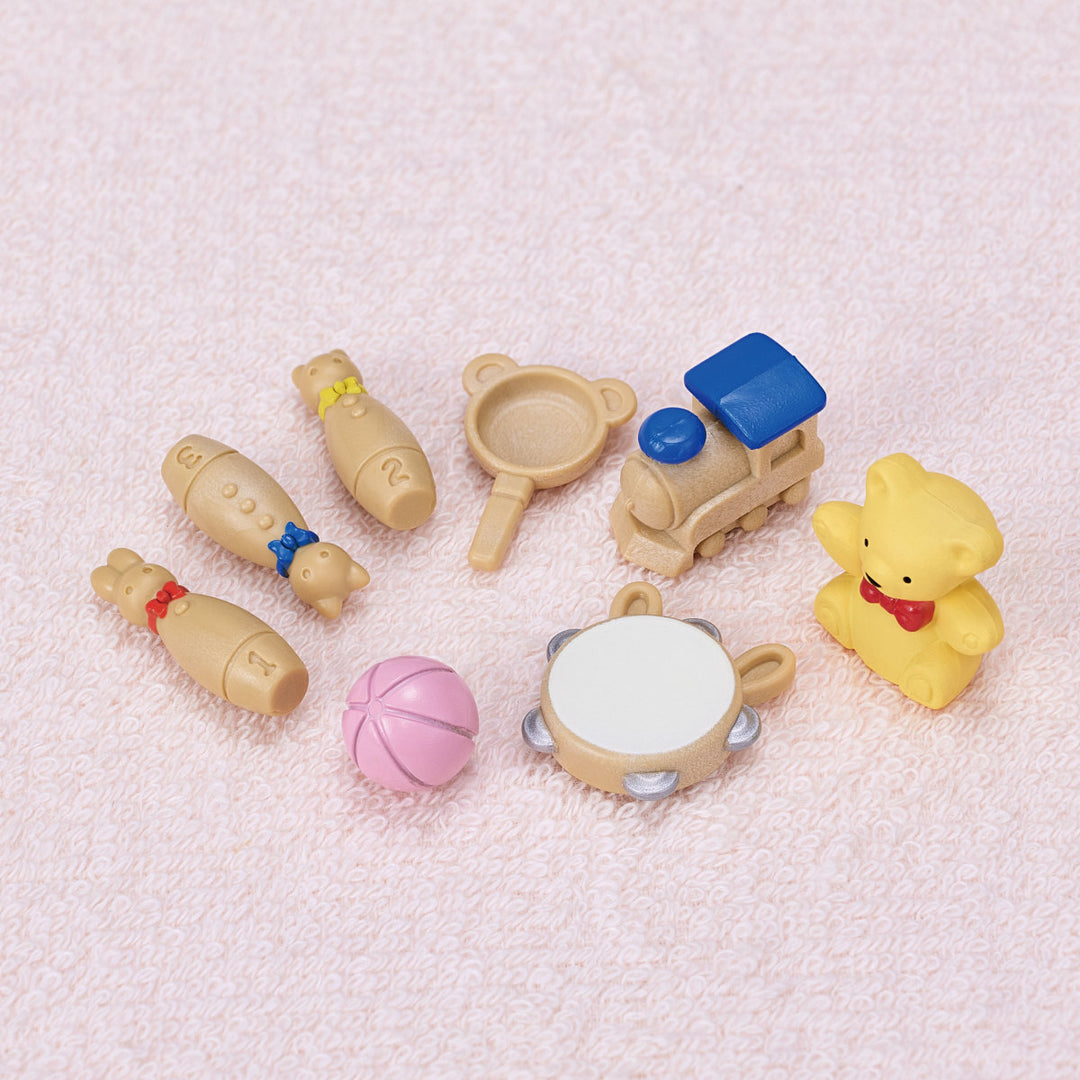 toys laid on on light pink carpet for baby calico critters