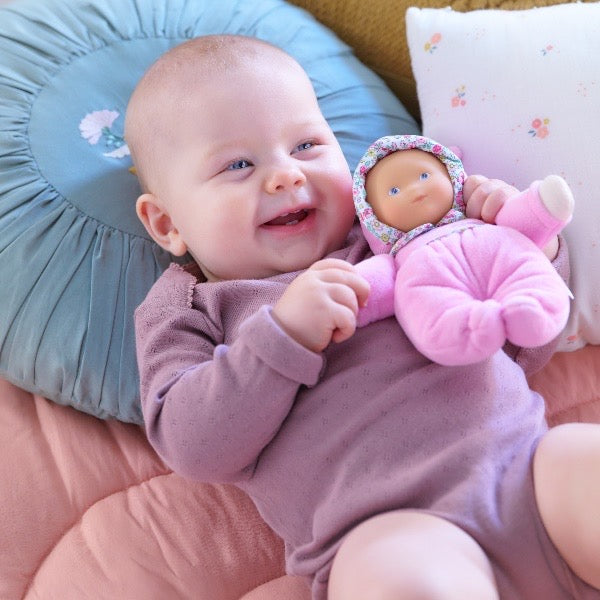 baby with blossom doll