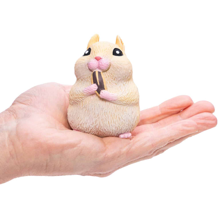 yellow hamster sitting in palm