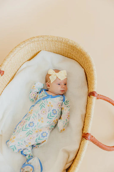 baby wearing sleep sack wearing matching bow