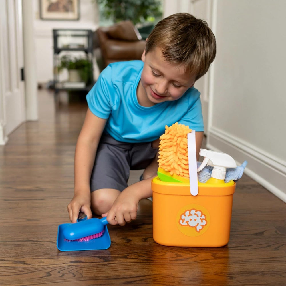 little boy playing with cleaning kit