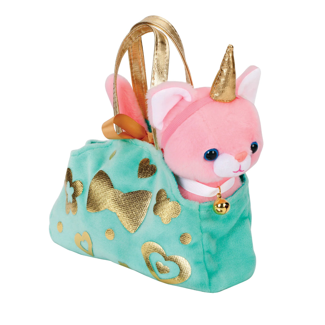 cuddly kitten in decorated carrier purse