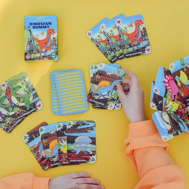 top view of kid playing dinosaur rummy