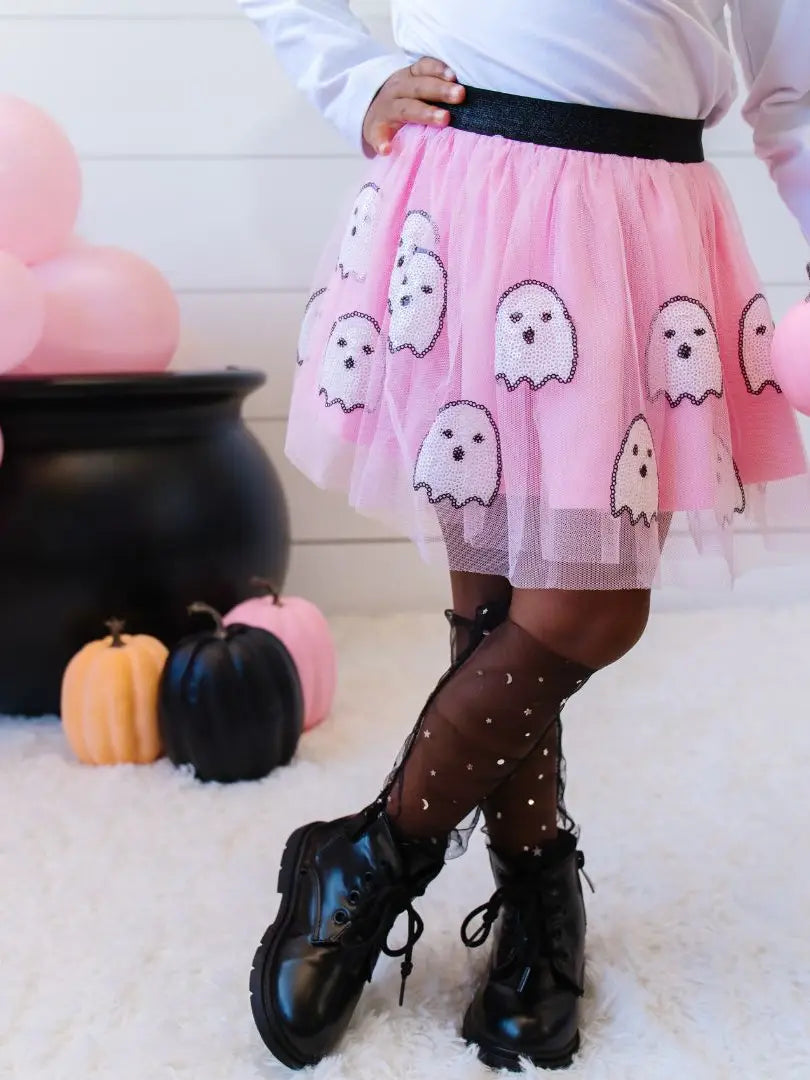 Child wearing Pink tulle skirt with black elastic band with sequin white ghosts