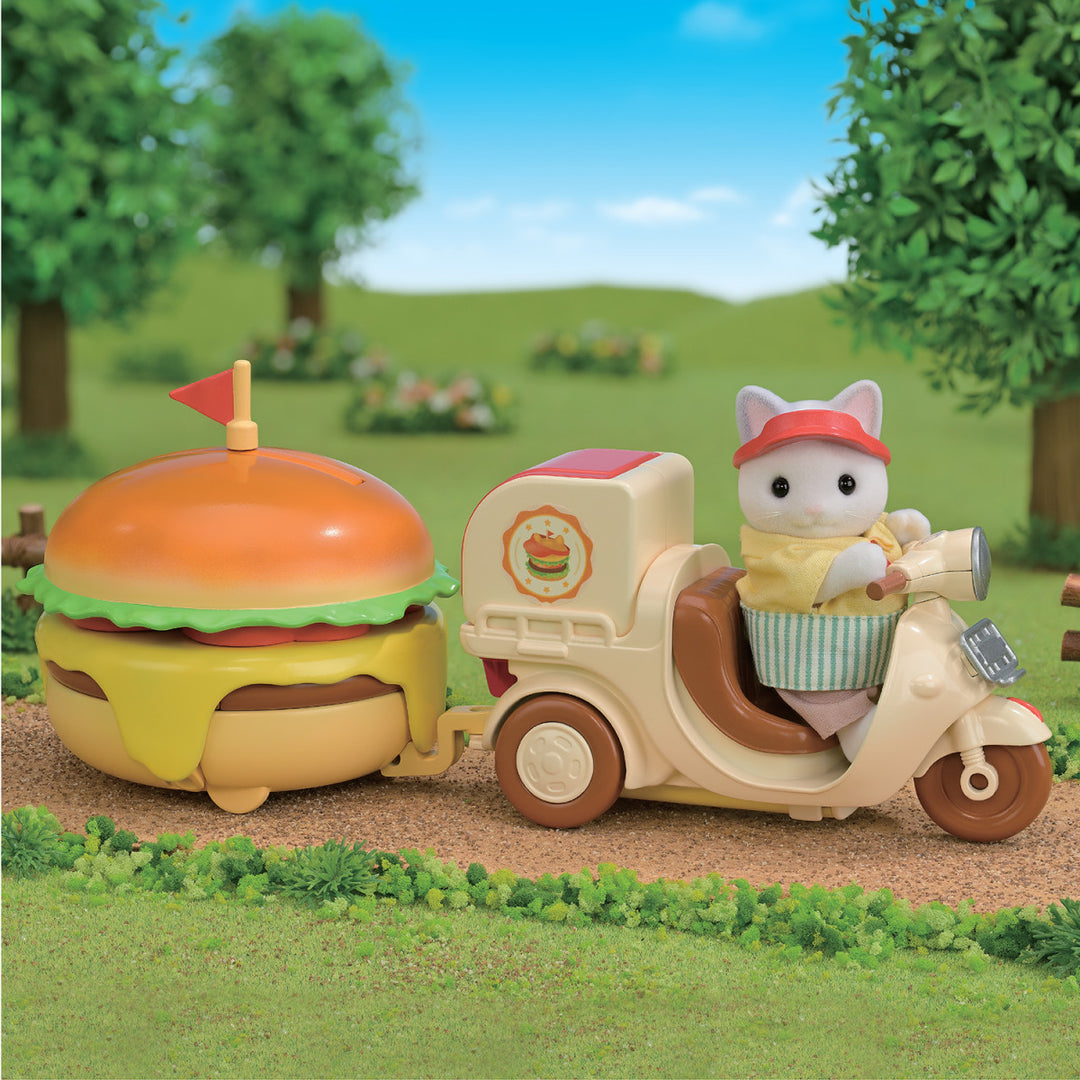 close up of cat driving bike with hamburger attached 