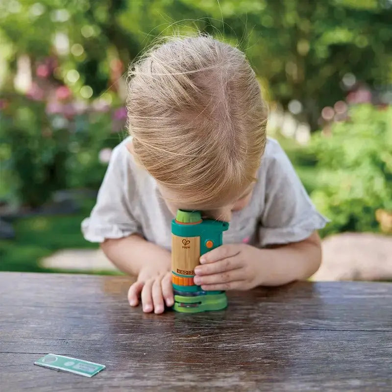 little kid using microscope