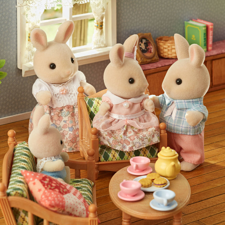 Calico Critter Milk Rabbit Family of Mother, Father, Son and Daughter sitting in living room