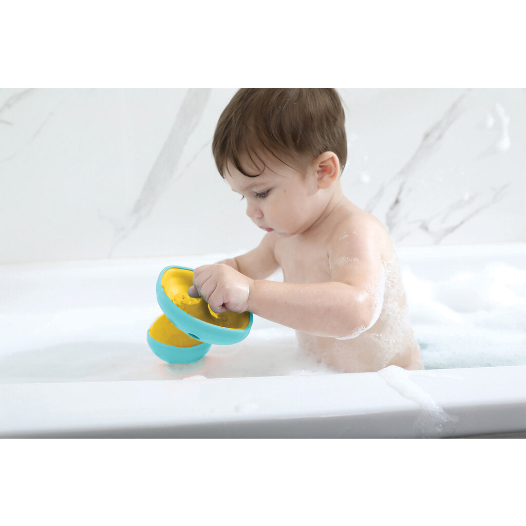 little boy playing with tub sub in bath