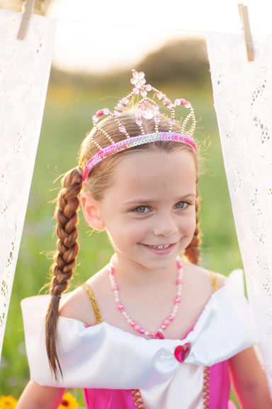 child modeling tiara and wearing matching sleeping princess dress