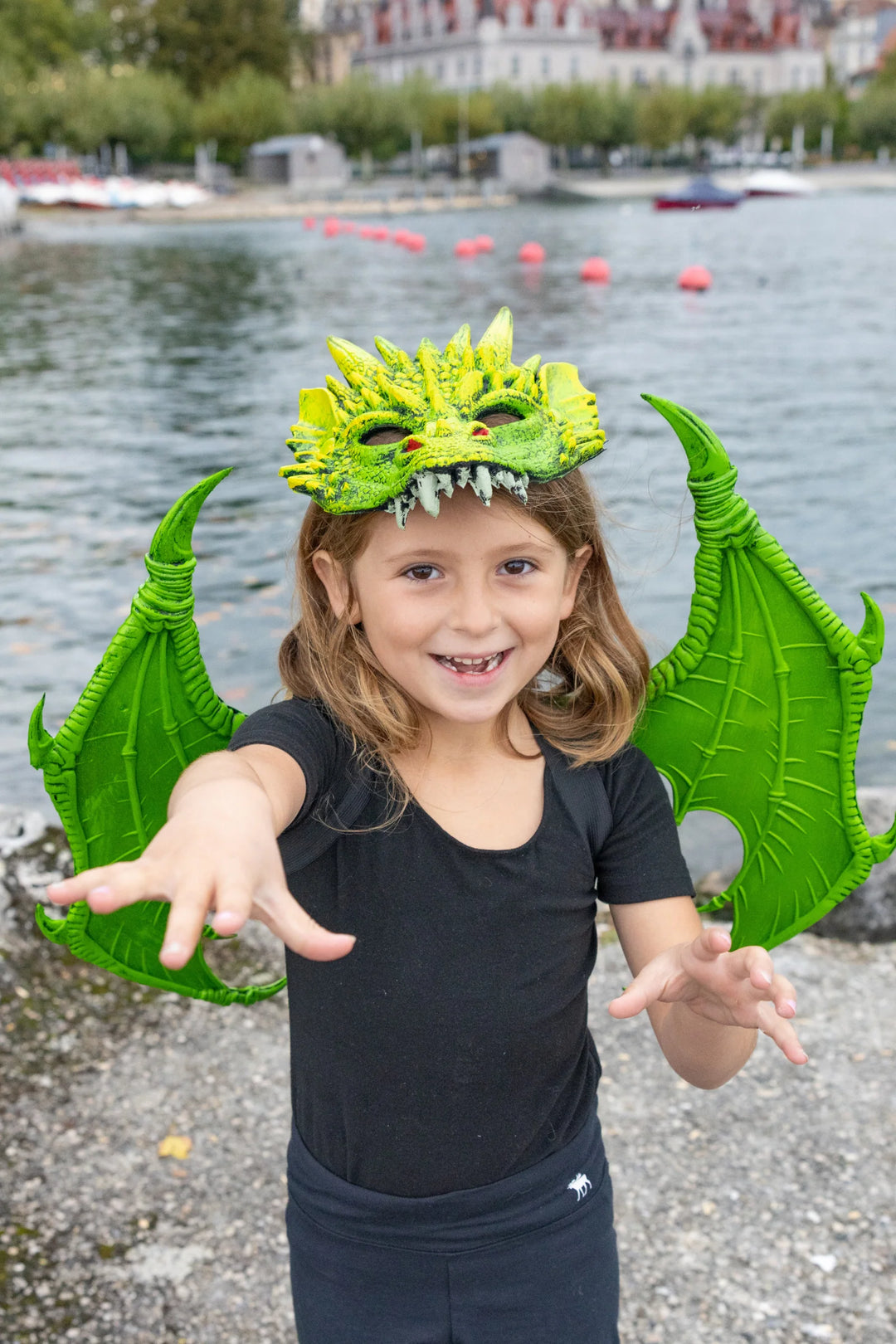 picture of child wearing wings and matching dragon mask