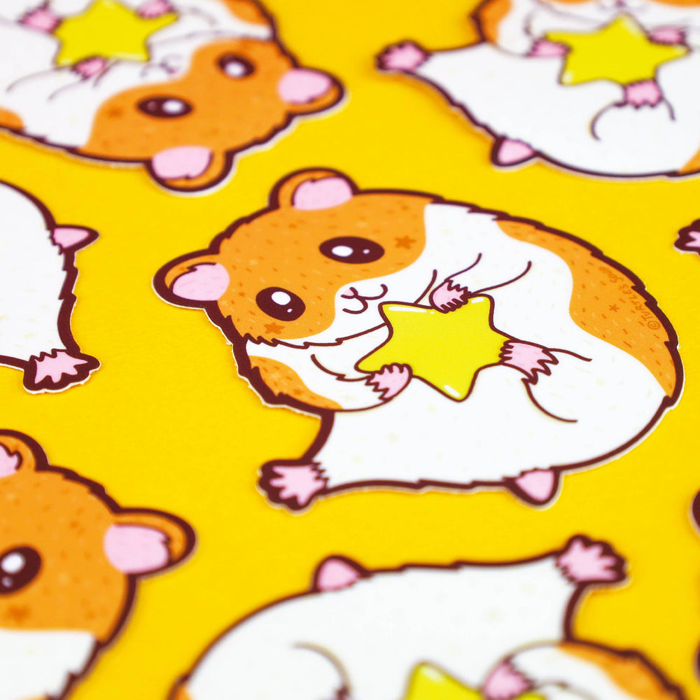 scattered ultra cute hamster holding a star vinyl stickers on yellow background