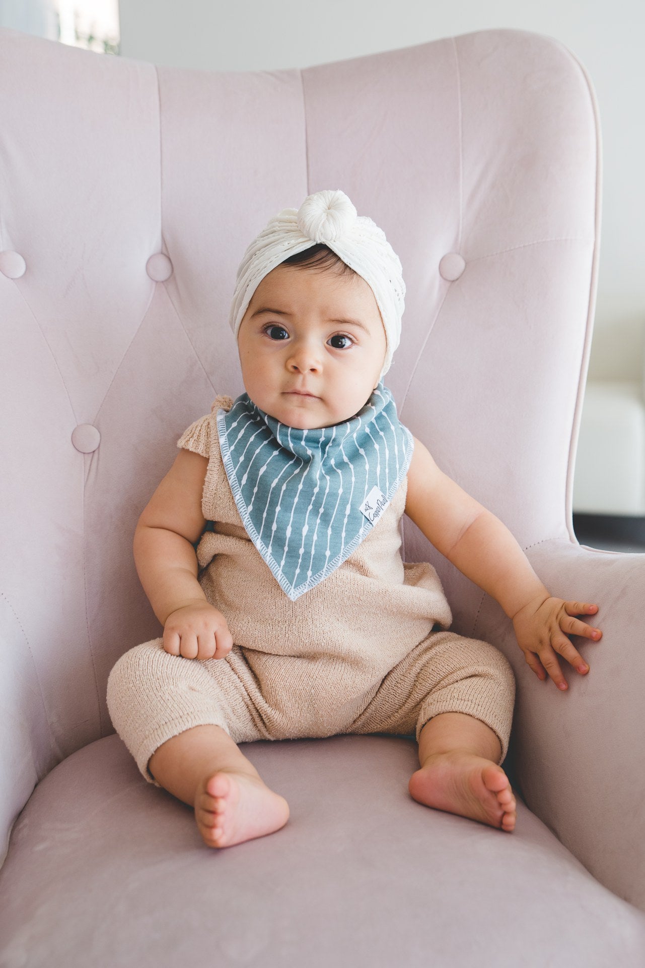 baby wearing blue bib