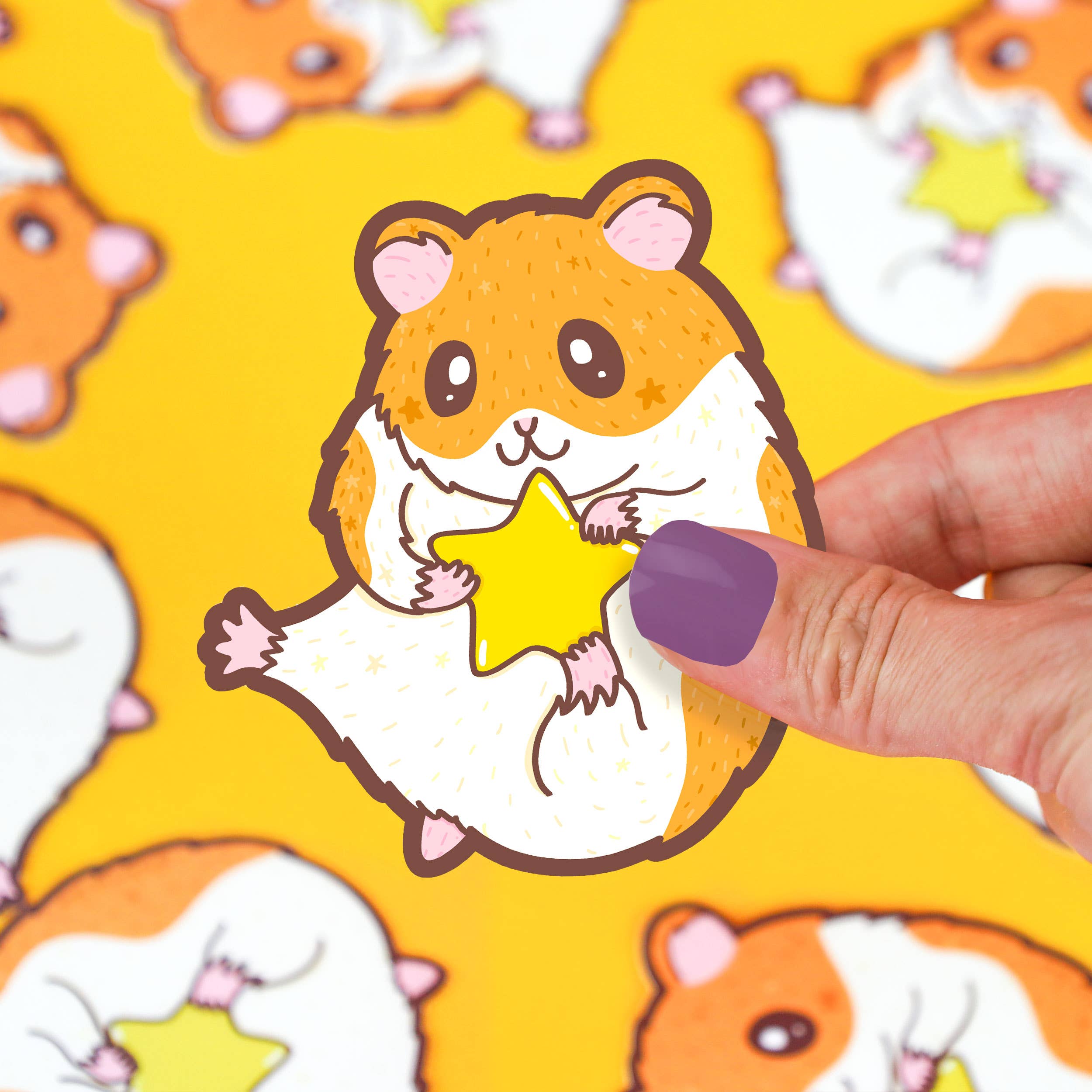 ultra cute hamster holding a star vinyl sticker