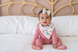 baby wearing floral bib