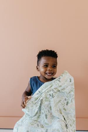 young kid seen cuddling with blanket