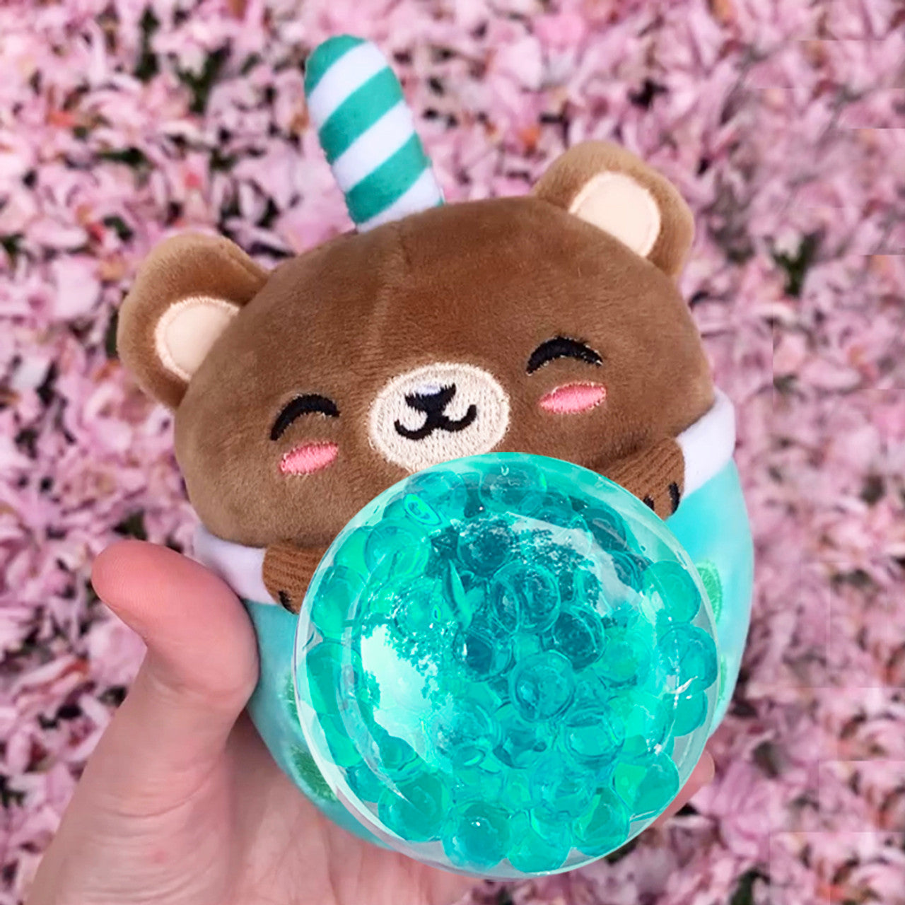 Squish toy being squished to show orbee balls in the inside