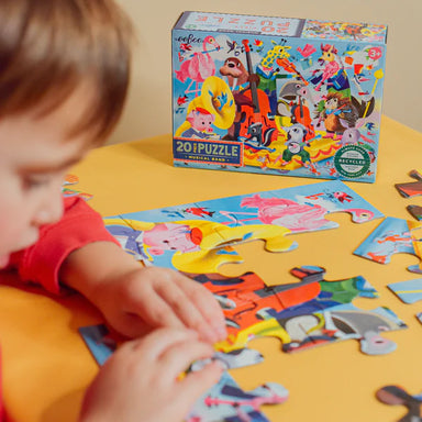 child putting together puzzle pieces