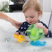 baby playing with toys in bath