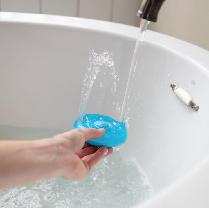 blue toy being demo'd in tub
