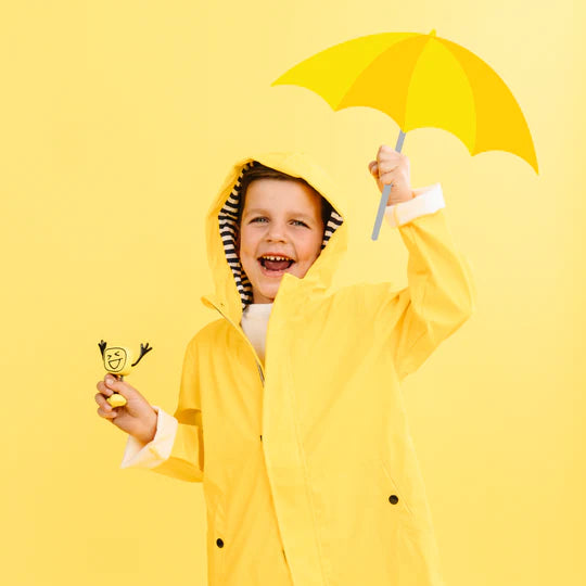 boy in yellow outfit holding yellow Alex glopal