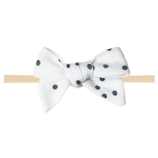 white bow with black dots