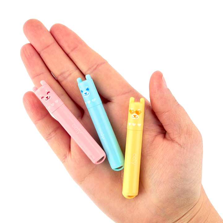 highlighters shown in the palm of someones hand to show size