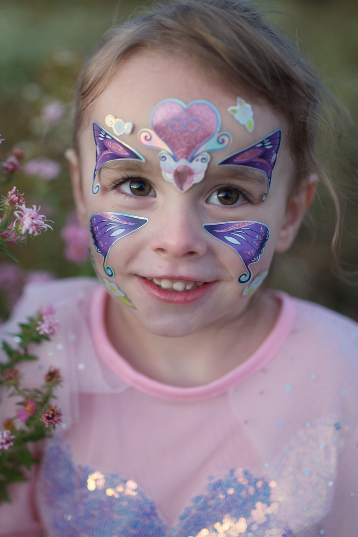 kid wearing the butterfly face stickers