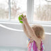 kid playing with green rainball