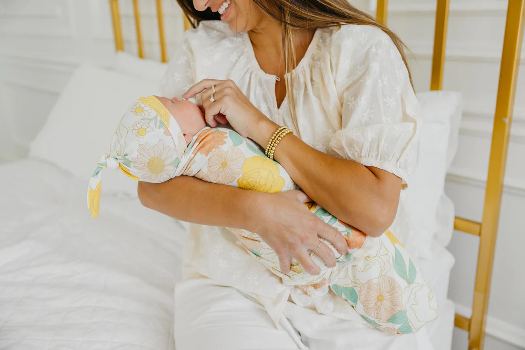 baby swaddled in blanket and wearing matching hat