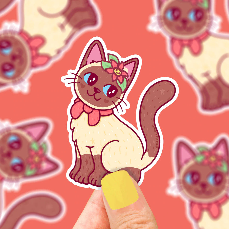 cute siamese cat sticker being held by a hand